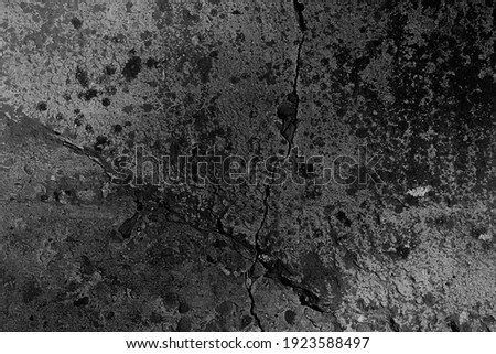 gray asphalt wall with cracks background