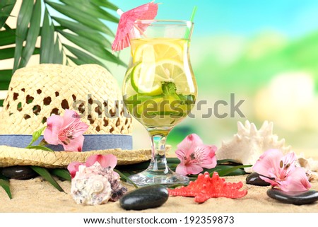 Refreshing cocktail on sand beach 