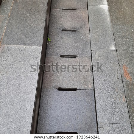Concrete rain gutter cover after raining