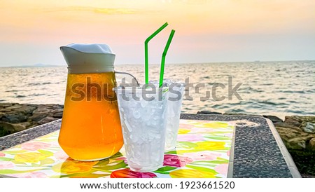 Draft beer with a glass of ice with the sunset time. A beautiful picture Beside the beach with the sea breeze blowing 