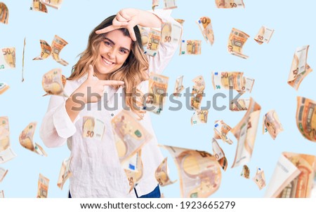 Young caucasian woman wearing casual clothes smiling making frame with hands and fingers with happy face. creativity and photography concept.