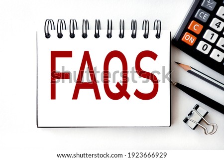FAQs. text on white notepad paper on white background NEXT TO THE CALCULATOR.