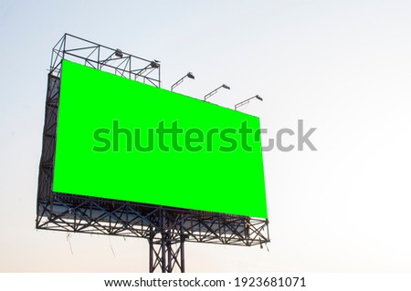 Green billboard on sky background