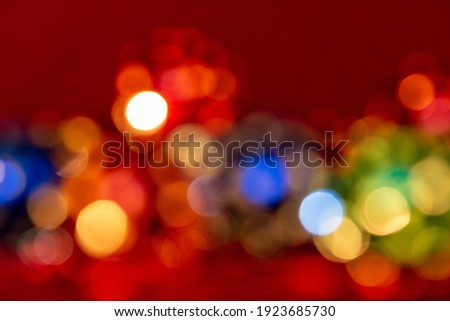 Defocused Christmas and new year bokeh lights, large abstract blurred bokeh, multi-colored bright garland of yellow, red, green and blue color, festive background for holidays, horizontal photo