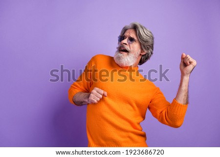 Photo of aged man happy positive smile have fun enjoy music dance isolated over violet color background Royalty-Free Stock Photo #1923686720