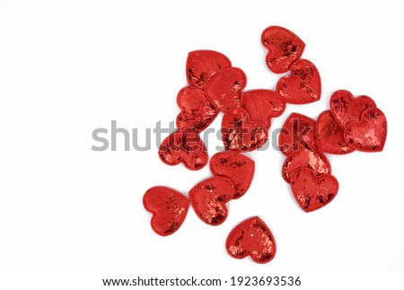 red textile small hearts on a white background, festive background, top view