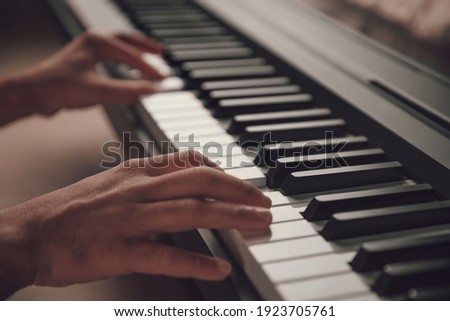 Musician Hands playing the piano closeup