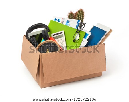 Cardboard box full with office supplies