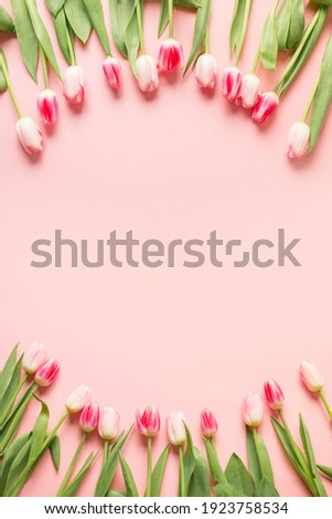 Border of pink tulips. Spring vertical greeting card with copy space.