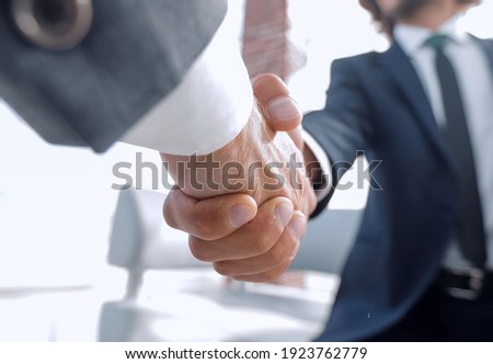 Close-up of two business people shaking hands