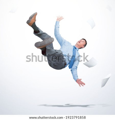 Man in office clothes falls down with sheets of paper on light background. Falling markets and bankruptcy concept 
