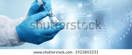 Coronavirus vaccine concept and background. Medical hand with vaccine and syringe Royalty-Free Stock Photo #1923803231