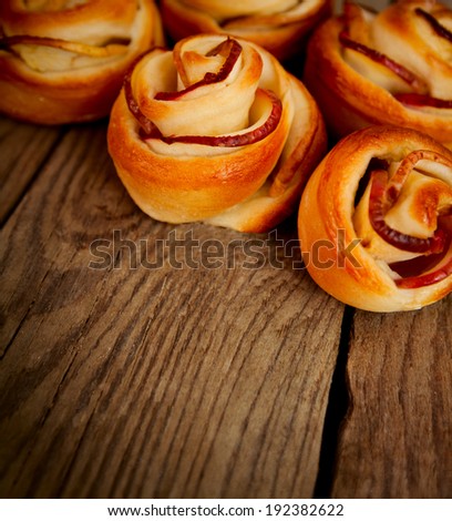 Tasty homemade apple cakes over wooden background