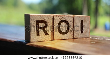 ROI Return on Investment written on a wooden cubes. Business accounting financial concept