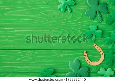 St. patrick's day congrats concept. Top above overhead close up view photo image of golden horseshoe and clover leaves isolated bright color green table desk with copy space for advert