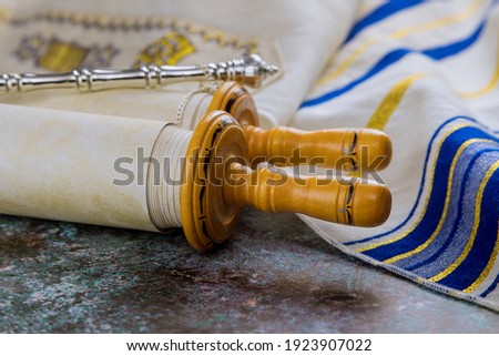 Prayer book with torah scroll and prayer shawl tallit Jewish Orthodox religious symbols Royalty-Free Stock Photo #1923907022