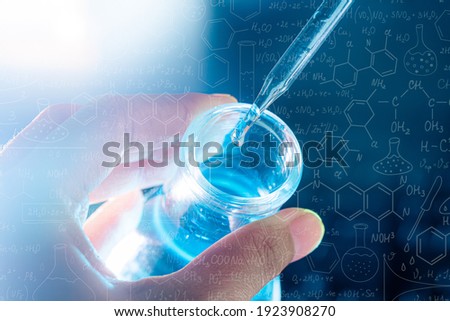 hand of scientist holding flask with lab glassware and test tubes in chemical laboratory background, science laboratory research and development concept Royalty-Free Stock Photo #1923908270