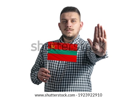 White guy holding a flag of Transnistria and with a serious face shows a hand stop sign isolated on a white background.