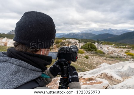 photo of unrecognized photographer taking photos in the countryside.