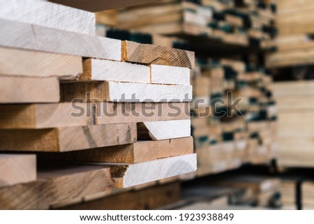 Stacks of lumber being stored in a warehouse Royalty-Free Stock Photo #1923938849