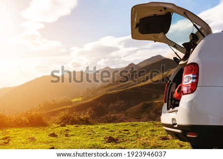 Open off-road car trunk with luggage inside on a mountain at sunset. holidays and weekends. Active turism. Royalty-Free Stock Photo #1923946037
