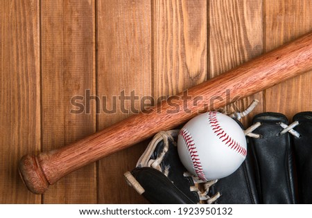 Baseball bat, glove and ball on wooden floor.  Sport theme background with copy space for text and advertisment