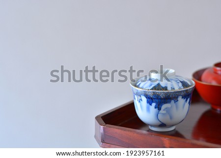 picture rice bowl. put on a Japanese lacquer serving tray. 

This is a very fine example of Japanese traditional antique “ imari ware ”. 
blurred background soft focus image. 