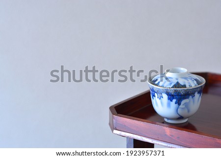 picture rice bowl. put on a Japanese lacquer serving tray. 

This is a very fine example of Japanese traditional antique “ imari ware ”.  
blurred background soft focus image. 