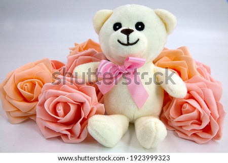Mother's Day Teddy Bear and pink roses. It is present for mom celebrated on various days in many parts of the world, most commonly in the months of March or May