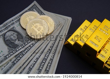 Gold bars and American one dollar bills. Scattered bitcoin digital cryptocurrency coin. Bank image and photo background.