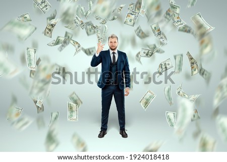 A man in a business suit tosses dollars up, it rains money. Business concept, bookmaker, sports betting, investment, passive income