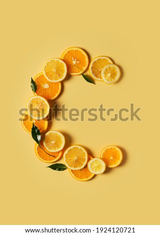 Citrus fruit food, orange and lemon shape of vitamin c flat lay on yellow background, copy space, top view, vertical Royalty-Free Stock Photo #1924120721