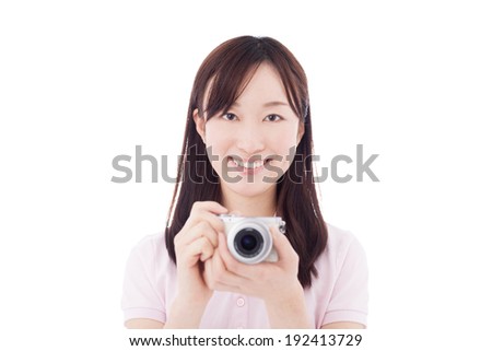 young woman taking pictures with digital camera, isolated on white background