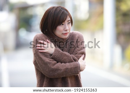 Image of a cold woman  Royalty-Free Stock Photo #1924155263