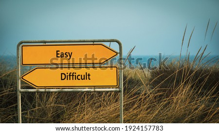 Street Sign the Direction Way to Easy versus Difficult Royalty-Free Stock Photo #1924157783