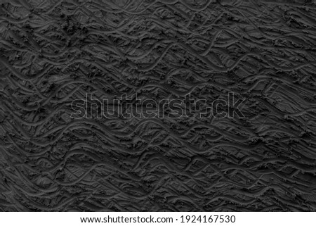Surface of black plasticine texture for background.