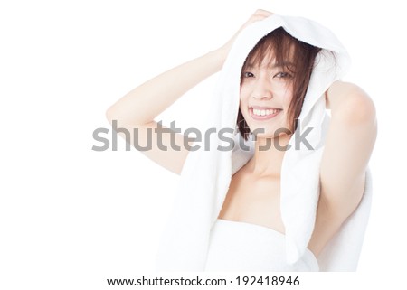 young woman drying her hair with towel, isolated on white background