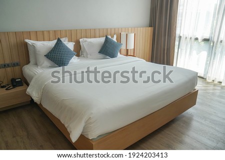 minimal double bed with white mattress in luxury hotel bedroom Royalty-Free Stock Photo #1924203413