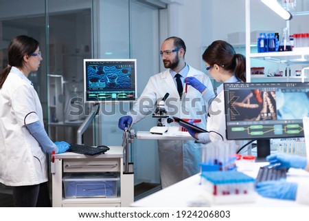 Scientists working In laboratory discovering genetic infection because of rare disease. Chemists in pharmaceutical lab examining sample for medical experiment with technology for medicine industry. Royalty-Free Stock Photo #1924206803