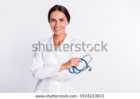 Photo of charming positive young woman therapist wear formal coat holding stethoscope empty space isolated white color background