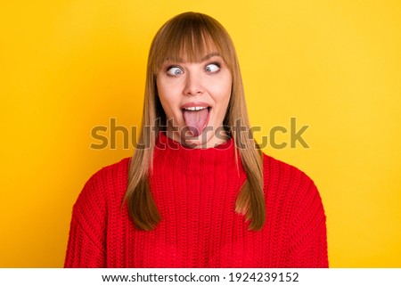 Photo of blond nice optimistic lady tongue out crossed eyes wear red sweater isolated on bright yellow color background