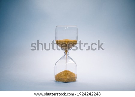 hourglass with golden sand pouring inside, eternal time, infinity, business time Royalty-Free Stock Photo #1924242248