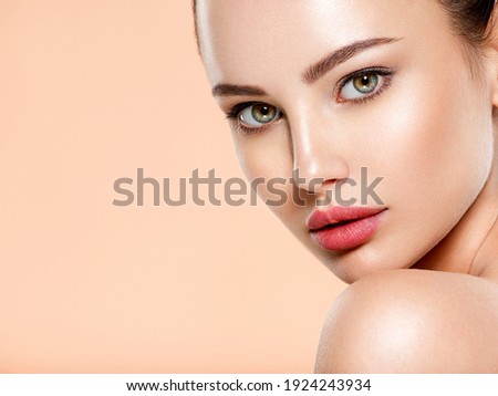 Beautiful face of young woman with health fresh skin. Portrait of beautiful  brunette woman with clean face. Closeup face of young adult woman with clean fresh skin. Skin care.