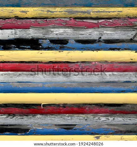 Old faded painted wooden boards with flaking paint on striped pattern for use as a background or texture