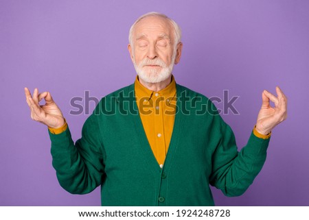 Photo of nice aged person closed eyes hands fingers meditate isolated on pastel violet color background