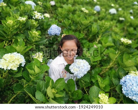 Asian woman in the Hydrangea garden