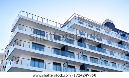 Condominium and apartment building with  symmetrical modern architecture in the city downtown. Royalty-Free Stock Photo #1924249958