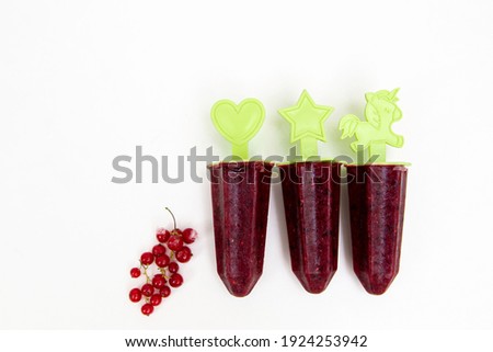 homemade homemade fruit and berry ice cream on a white background on sticks in the form of figurines