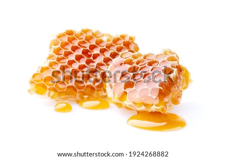 Honeycomb with honey drop on white background Royalty-Free Stock Photo #1924268882