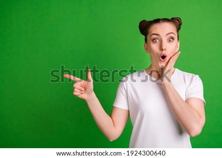 Portrait of pretty amazed funny girl demonstrating copy space wow new offer isolated over vibrant green color background